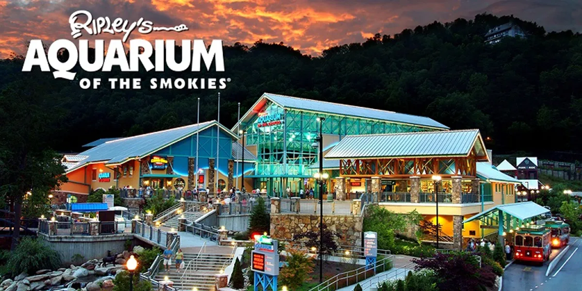A bright exterior shot of the Ripley's Aquarium building, featuring its inviting entryway, landscaped surroundings, and clear signage. The scene is energetic, hinting at the interactive and immersive experiences that await inside.